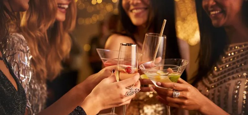 Friends clinking glasses together at a party